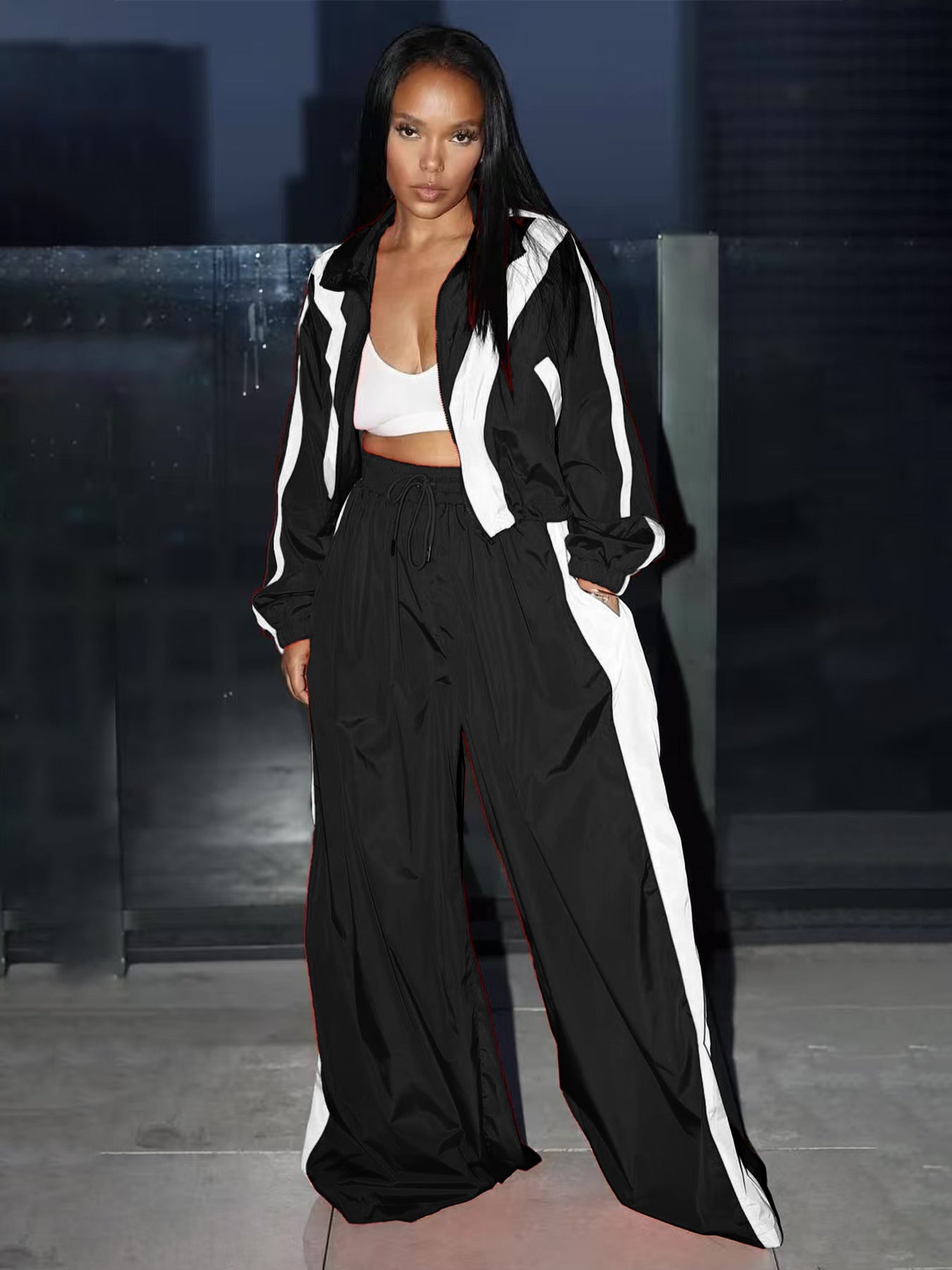Person wearing a black and white outfit with a blurred background