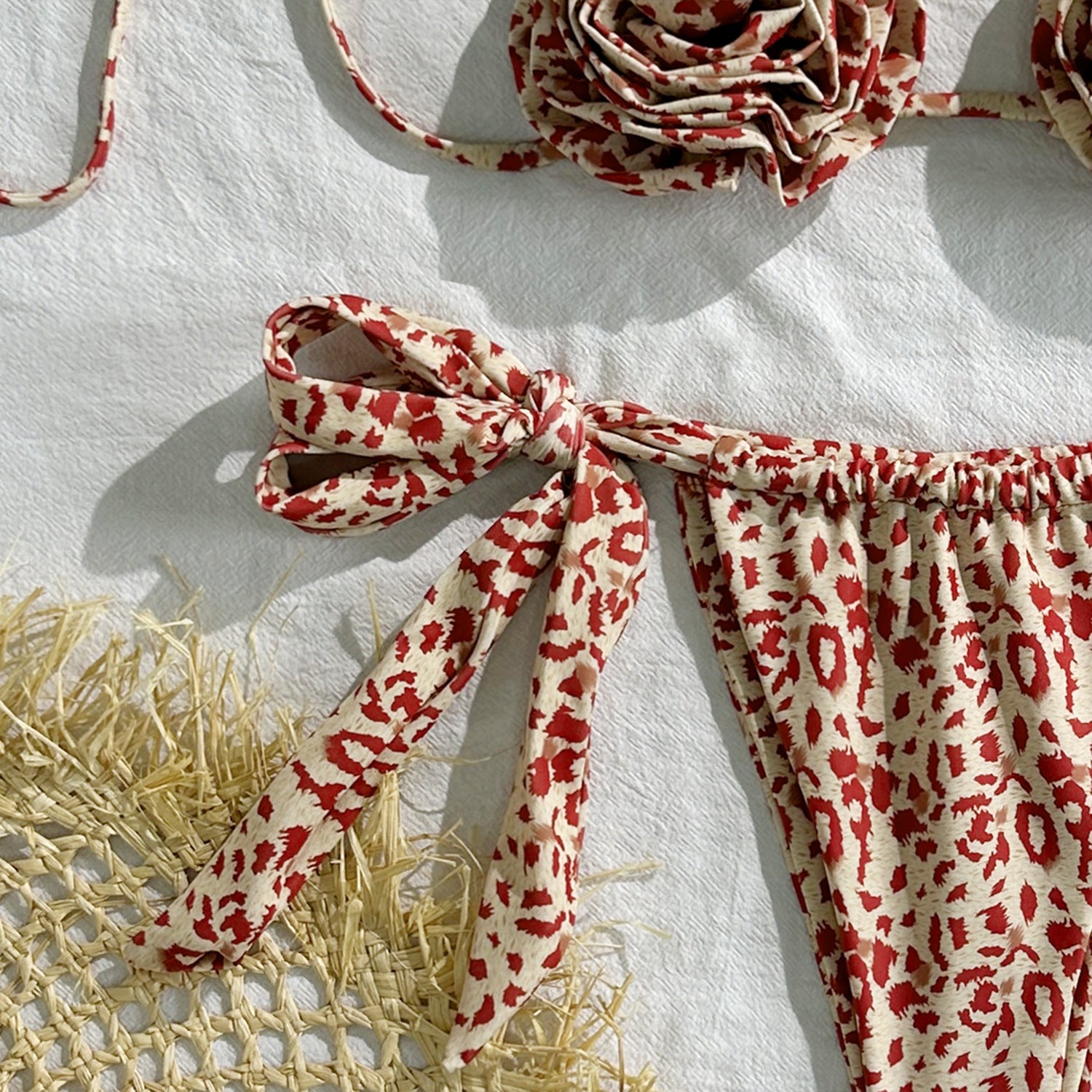 Red and white patterned fabric with tied ends on a white background