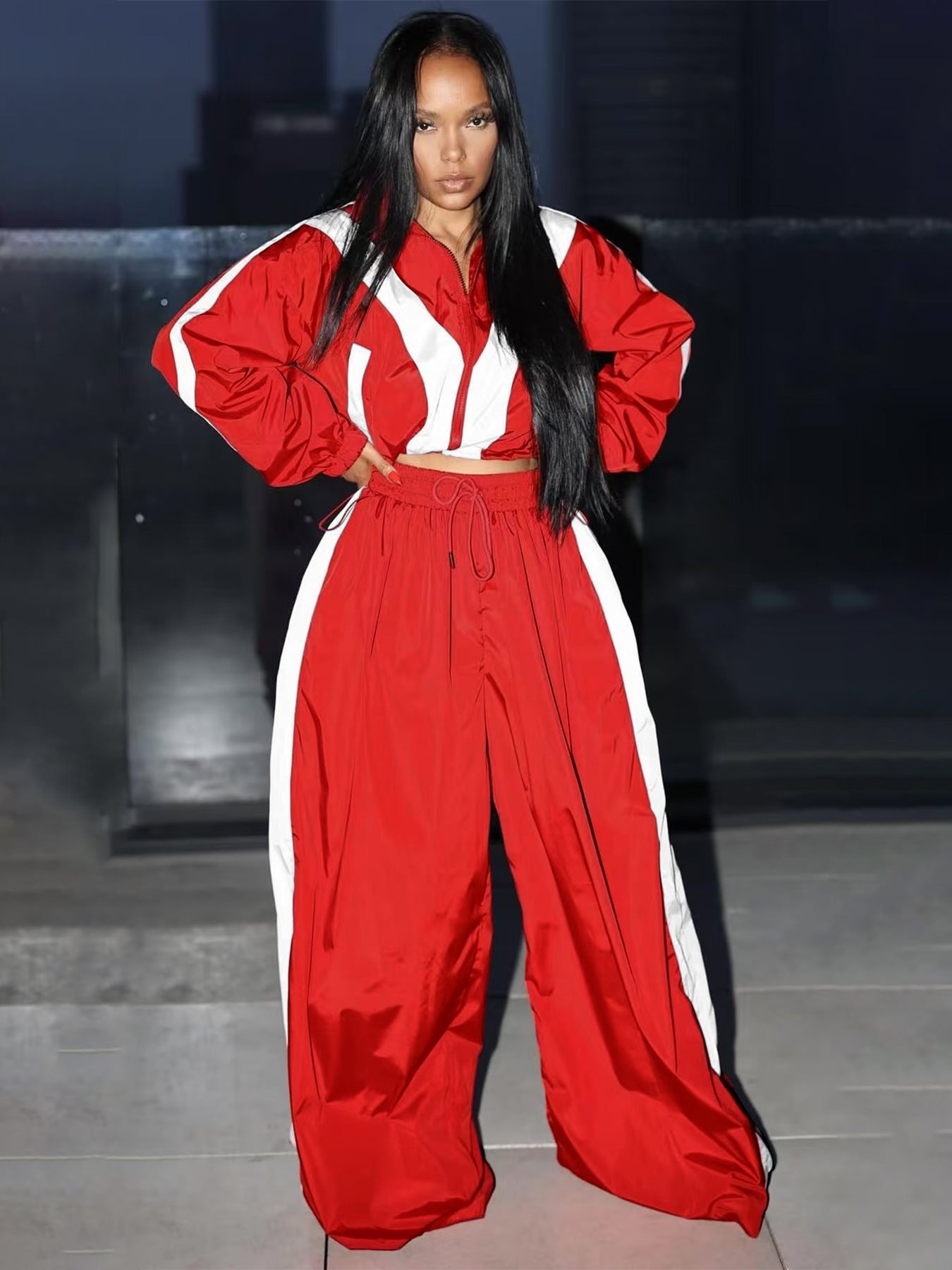 Person wearing a red and white outfit on a dark background