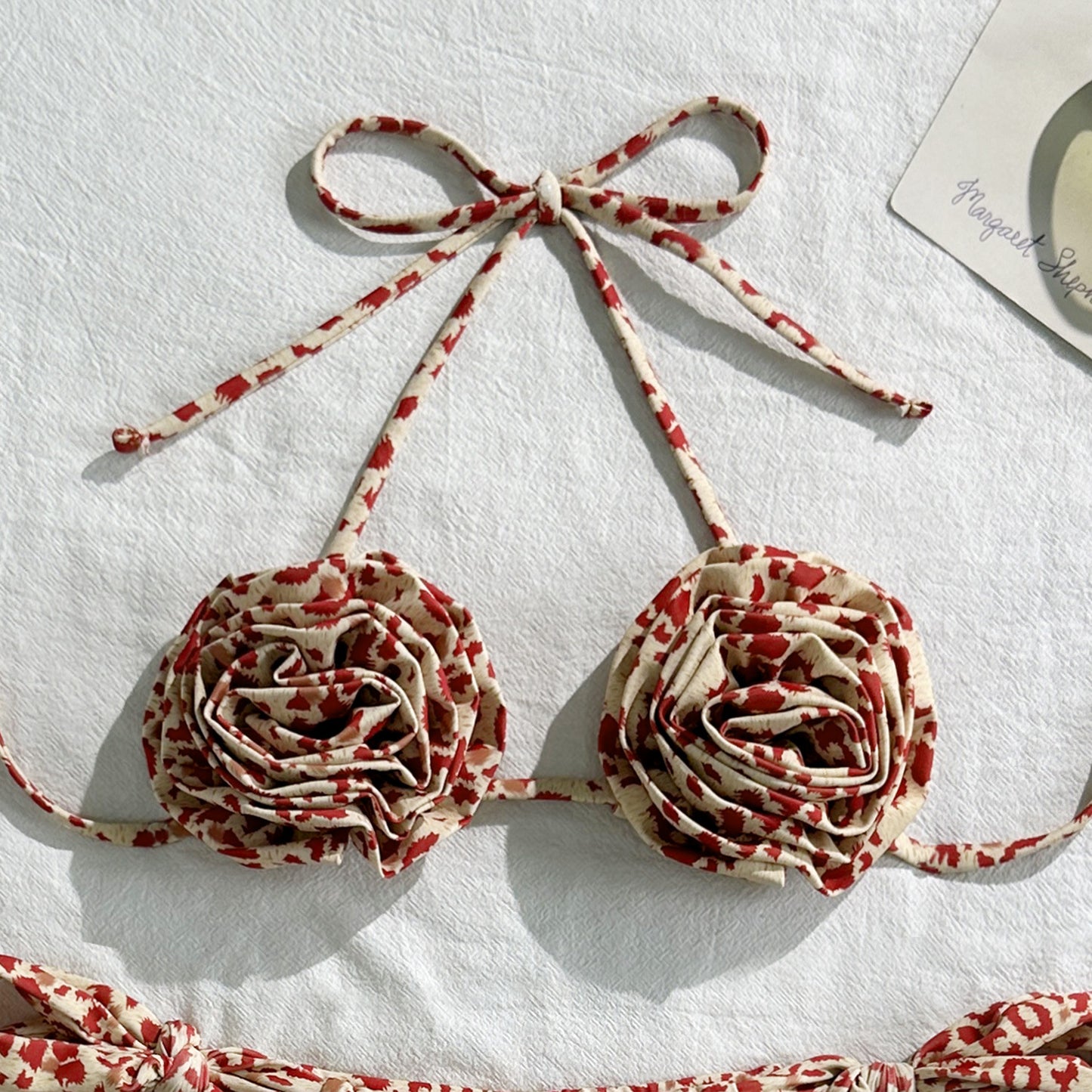 Floral-patterned bra with red and beige design on a white background