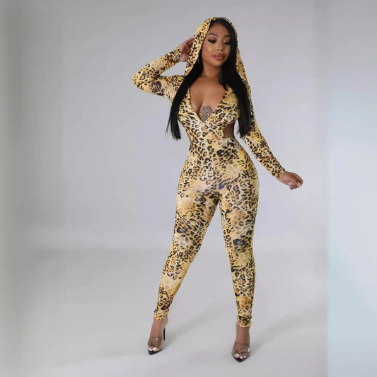 Woman wearing a leopard print hoodie and jumpsuit on a gray background
